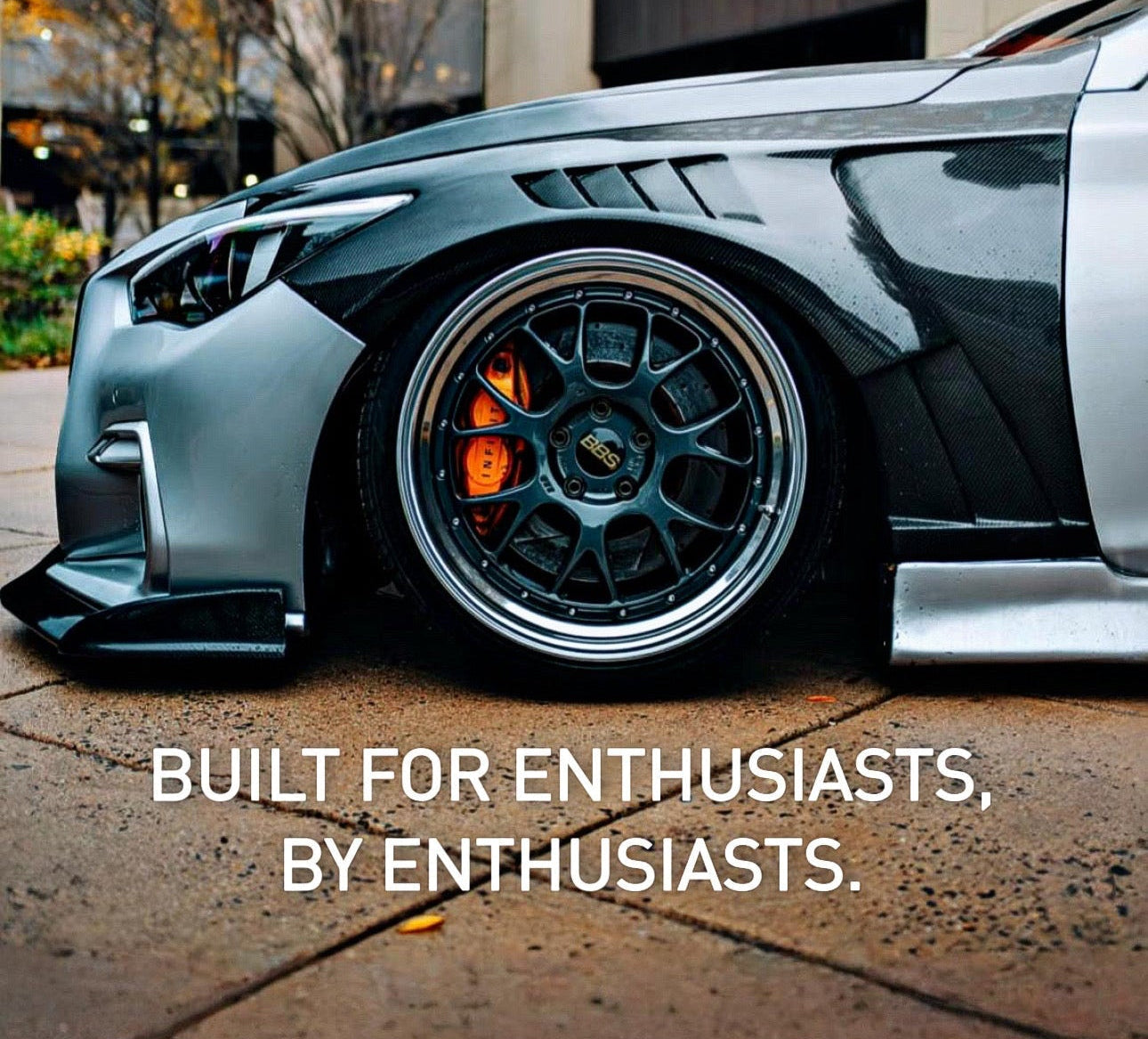 Car with text about premium VQ and VR upgrades in an urban setting